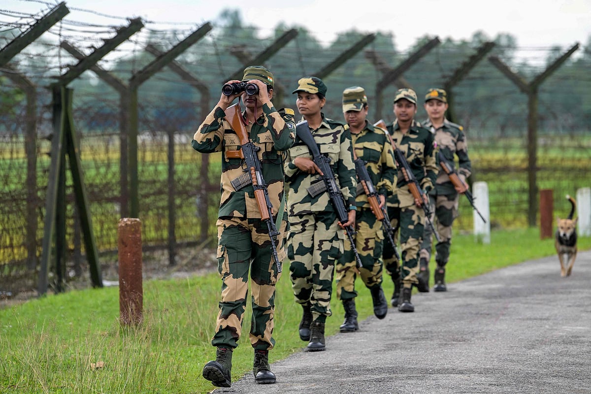 Border Security Force (BSF) women personnel patrol along the borderline fence at the India-Bangladesh border in Golakganj, Dhubri district in India’s Assam State on 26 May 2025