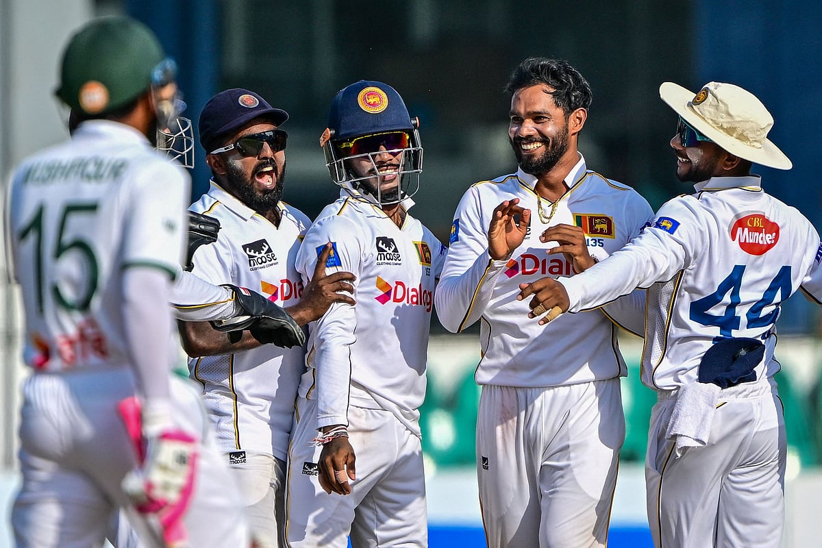 Sri Lanka's captain Dhananjaya de Silva (2R) celebrates with teammates after taking the wicket of Bangladesh's captain Najmul Hossain Shanto during the third day of the second Test cricket match between Sri Lanka and Bangladesh at the Sinhalese Sports Club (SSC) Ground in Colombo on 27 June, 2025.