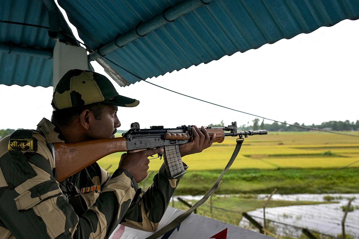 A Border Security Force (BSF) personnel stands armed on a guard tower at the India-Bangladesh border in Golakganj, Dhubri district in India’s Assam State on 26 May 2025