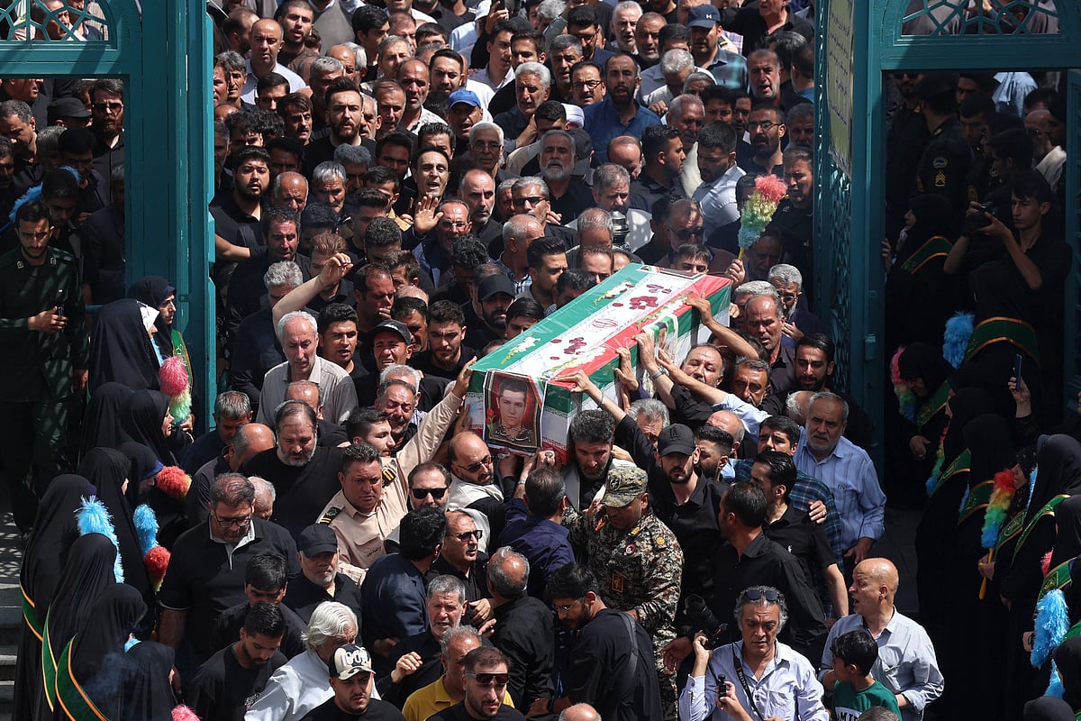 Mourners carry the flag-draped coffin of an Iranian soldier killed in an Israeli strike days ago, during his funeral procession in Tehran on 26 June, 2025