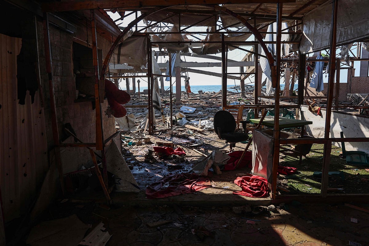 A Palestinian man inspect the damage at Al-Baqa cafeteria which was devastated in an Israeli strike on the Gaza City seafront on 30 June 2025