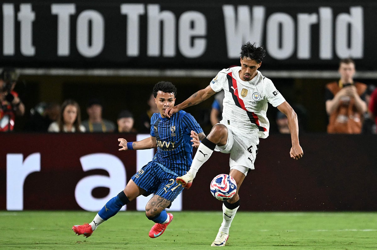 Al Hilal’s Brazilian midfielder #27 Kaio Cesar and Manchester City’s Dutch midfielder #04 Tijjani Reijnders fight for the ball during the FIFA Club World Cup 2025 round of 16 football match between England’s Manchester City and Saudi’s Al-Hilal at the Camping World stadium in Orlando on 30 June 2025