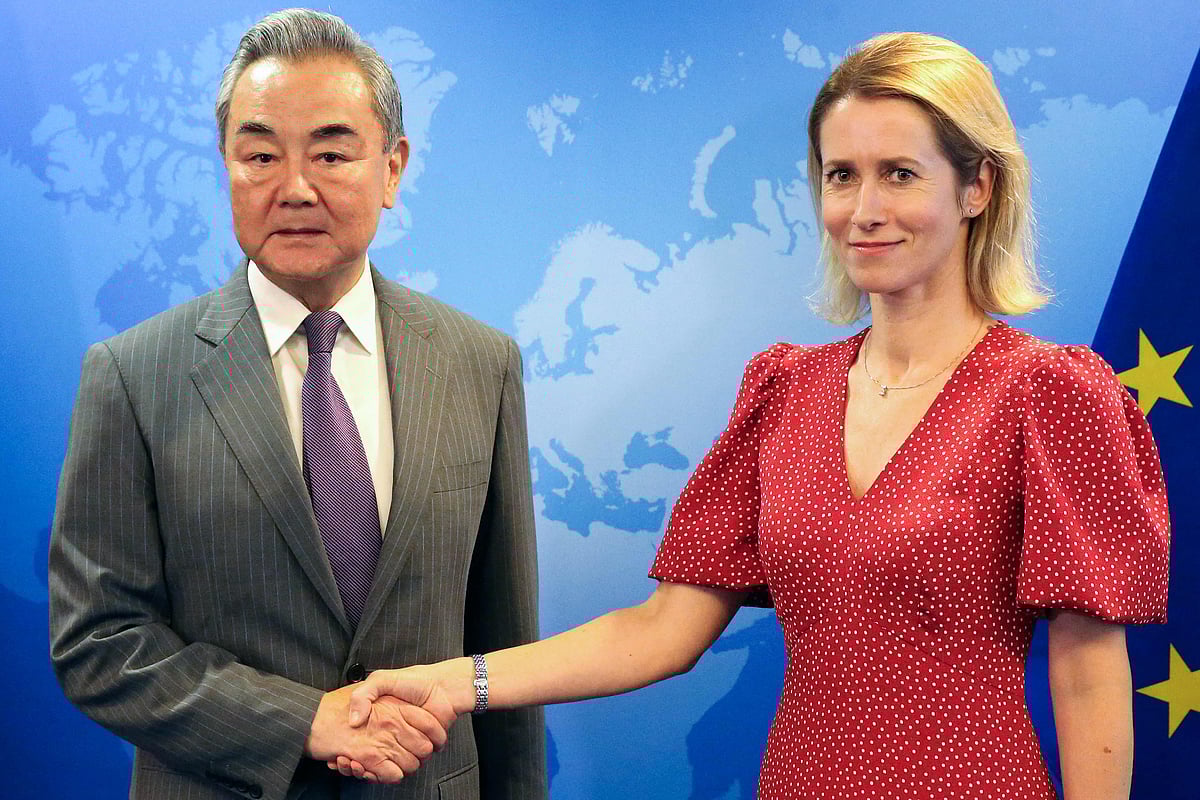 EU High Representative and Vice-President for Foreign Affairs and Security Policy Kaja Kallas (R) shakes hands with China’s Foreign Minister Wang Yi during a meeting as part of the 13th EU-China Strategic Dialogue, in Brussels, on 2 July 2025