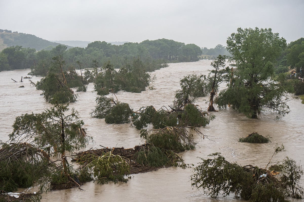Trees emerge from flood waters along the Guadalupe River on 4 July, 2025 in Kerrville, Texas, the United States.