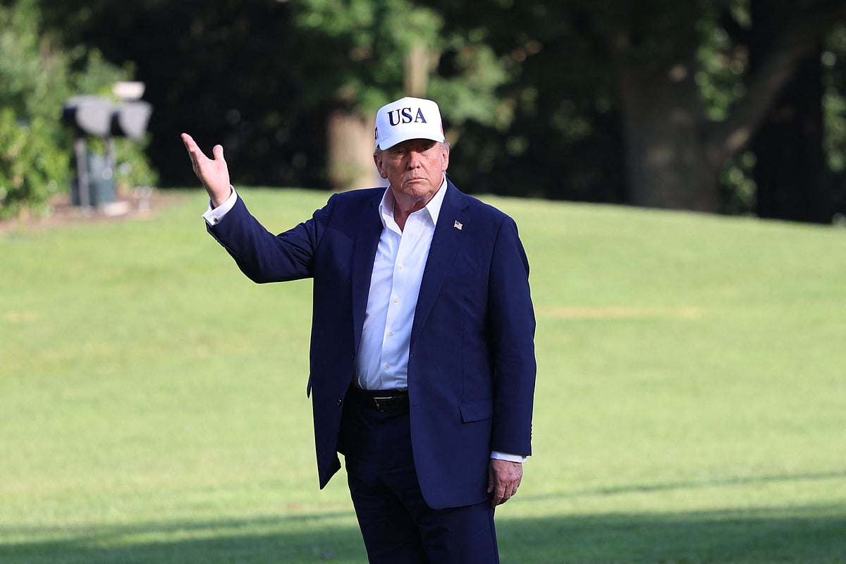 US President Donald Trump stops to gesture at the US flag as he walks on the South Lawn from Marine One to the White House in Washington, DC on July 6, 2025