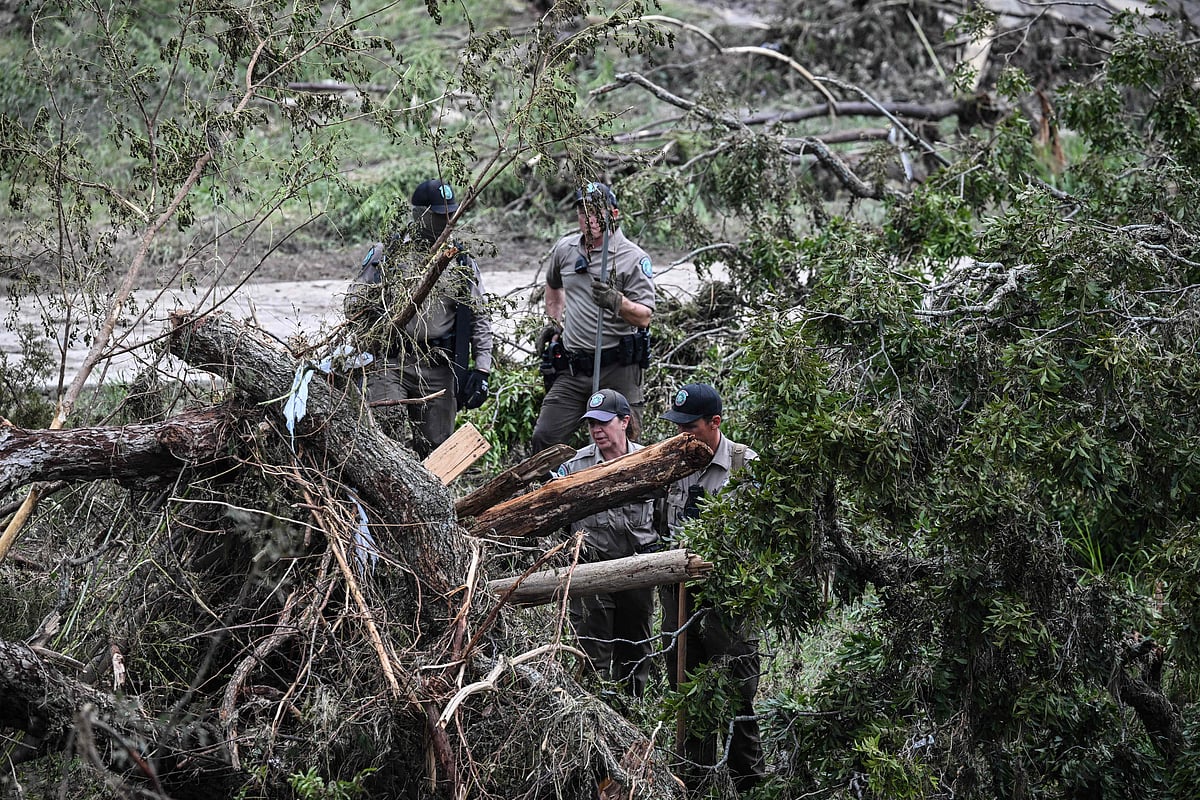 Members of a Texas Game Warden look for missing people on the Guadalupe River in Kerrville, Texas, on 6 July, 2025, following severe flash flooding that occured during the 4 July holiday weekend. Rescuers in Texas raced against time Sunday to find dozens of missing people, including children, swept away by flash floods that killed at least 78, as forecasters warned of new deluges.