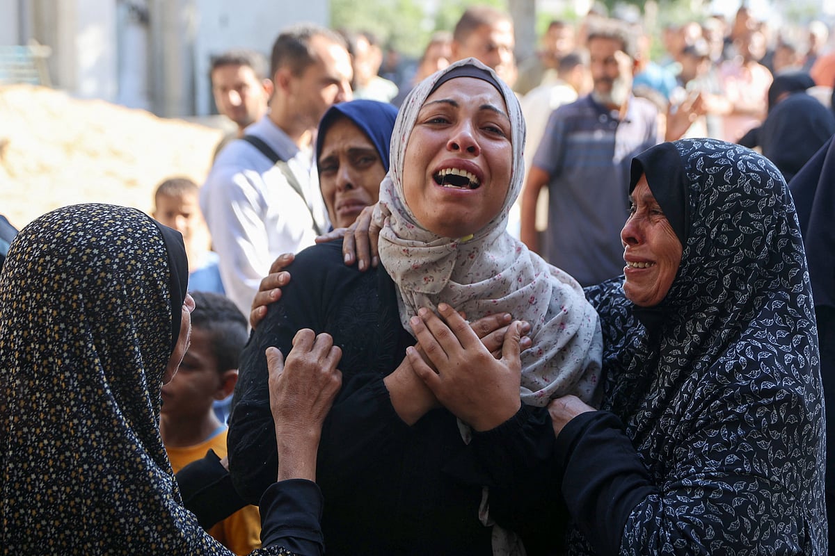 A Palestinian woman mourns a relative, killed in an Israeli strike, outside the al-Shifa hospital in Gaza City on 7 July, 2025