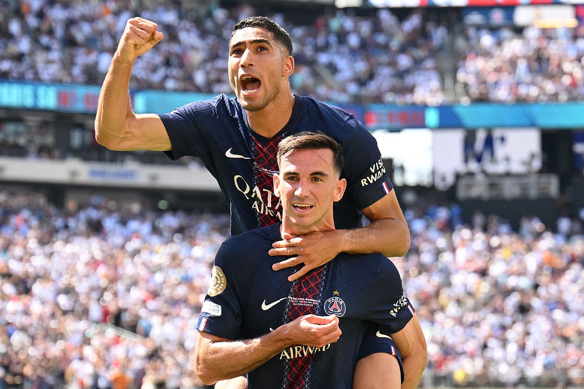 Paris Saint-Germain's Spanish midfielder #08 Fabian Ruiz celebrates scoring his team's third goal with Moroccan defender #02 Achraf Hakimi during the FIFA Club World Cup 2025 semifinal football match between France's Paris Saint-Germain and Spain's Real Madrid at the MetLife stadium in East Rutherford, New Jersey on 9 July, 2025
