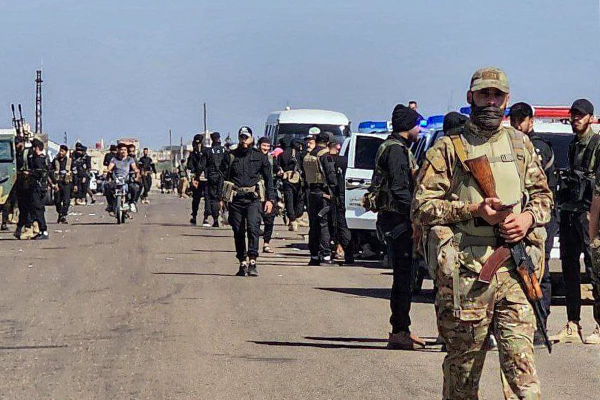 This handout picture released by the official Syrian Arab News Agency (SANA) shows Syrian army and security forces deploying in Sweida in southern Syria on 14 July, 2025 following clashes between Bedouin tribes and local fighters in the predominantly Druze city that left 37 killed according to the Syrian Observatory for Human Rights war monitor.
