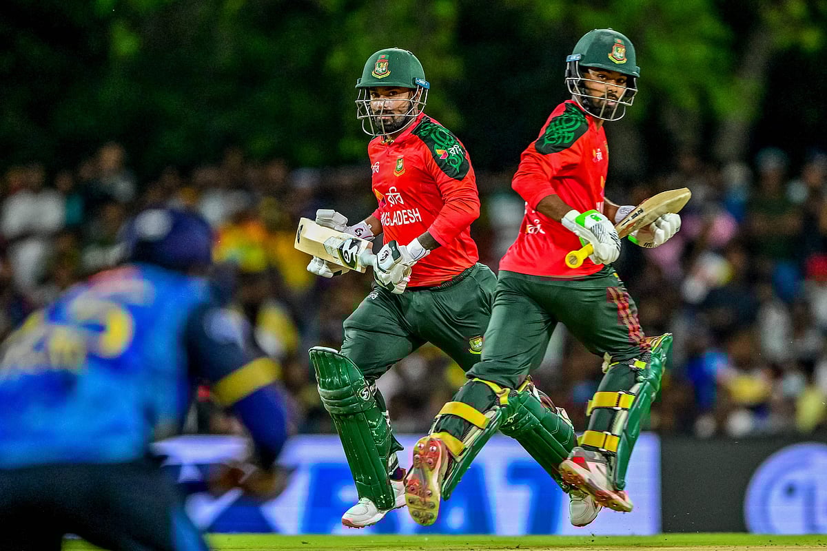 Bangladesh's Towhid Hridoy (R) and captain Litton Das run between the wickets during the second Twenty20 international cricket match between Sri Lanka and Bangladesh at the Rangiri Dambulla International Stadium in Dambulla on 13 July, 2025.