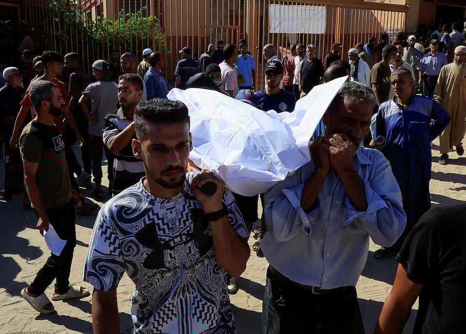 People carry a body as they mourn Palestinians who were killed in an incident on Wednesday while seeking aid in Khan Younis, at Nasser hospital in Khan Younis in the southern Gaza Strip on 16 July, 2025.