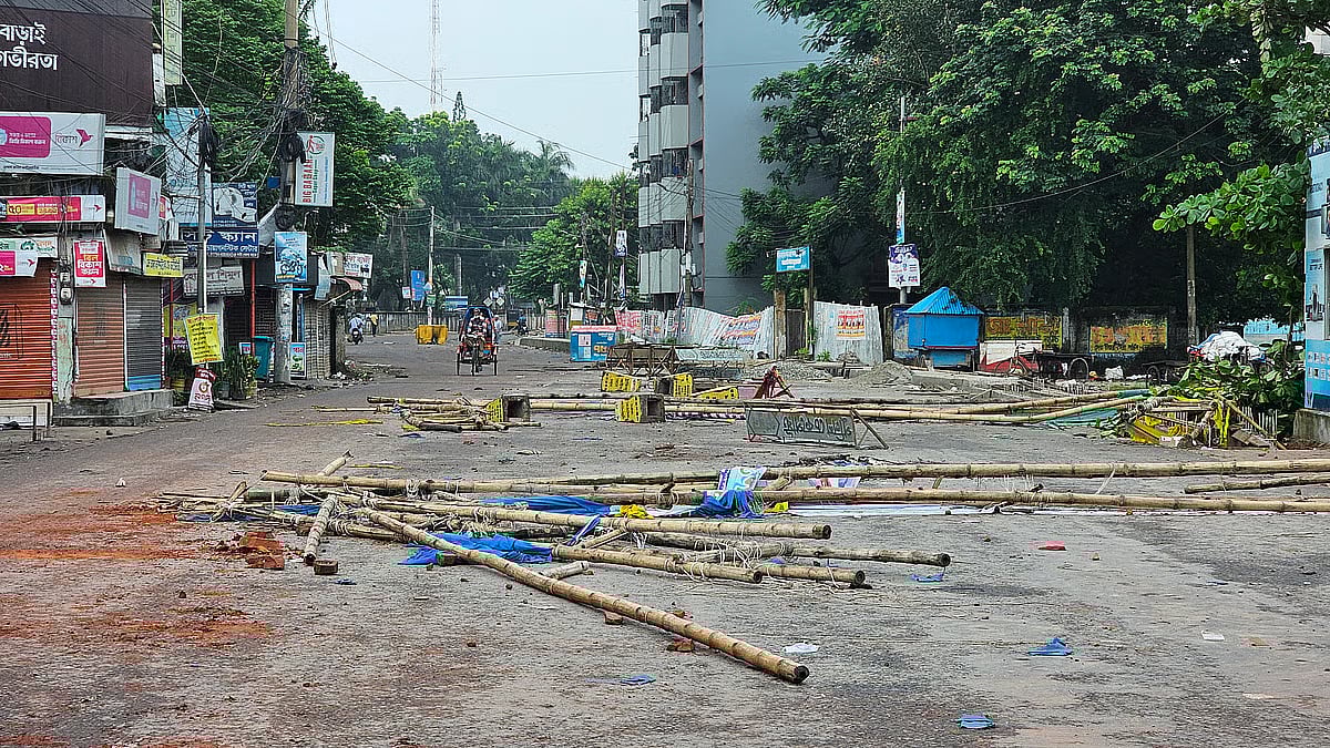 Bricks, stones, bamboo, and various other materials used to create obstructions are scattered across the road in Launchghat area of Gopalganj town. This photo is taken on 17 July 2025 morning.