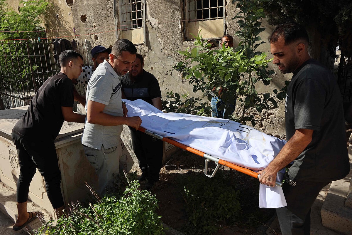 Men carry the body of one of two Christian Palestinians, killed earlier in an Israeli strike that hit the Holy Family Church in Gaza City, during their funeral on July 17, 2025.