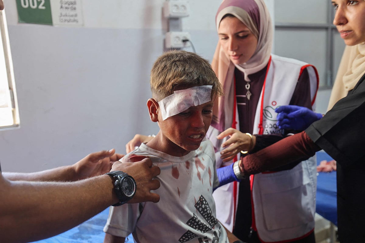 Palestinian casualties of an Israeli strike on an apartment at the Nuseirat refugee camp, receive care at Al-Awda hospital in the central Gaza Strip on 19 July, 2025.