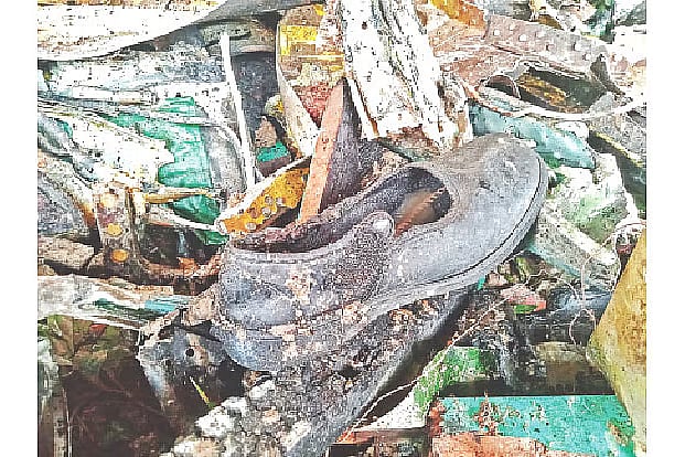 A half-burnt shoe lying in the debris