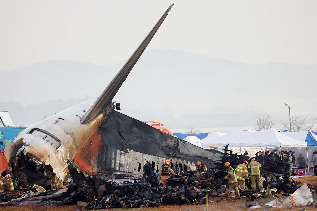 People work at the site where an aircraft went off the runway and crashed at Muan International Airport, in Muan, South Korea, 30 December, 2024.