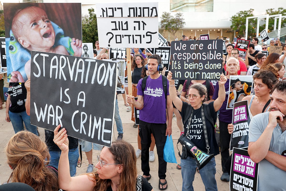 Israeli activists gather at HaBima Square for a protest march towards the Israeli defence ministry headquarters in Tel Aviv on 22 July, 2025 denouncing the ongoing food shortage and forced displacement of Palestinians in the Gaza Strip