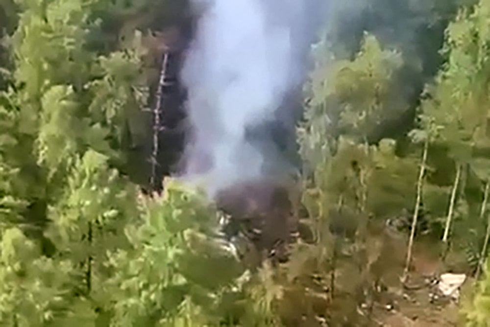 This video grab from a handout footage released by the Eastern Interregional Directorate for Transport of the Russian Investigative Committee on 24 July, 2025, shows an aerial view of the crash site of the Antonov AN-24 passenger plane outside the town of Tynda in Russia's far eastern Amur region