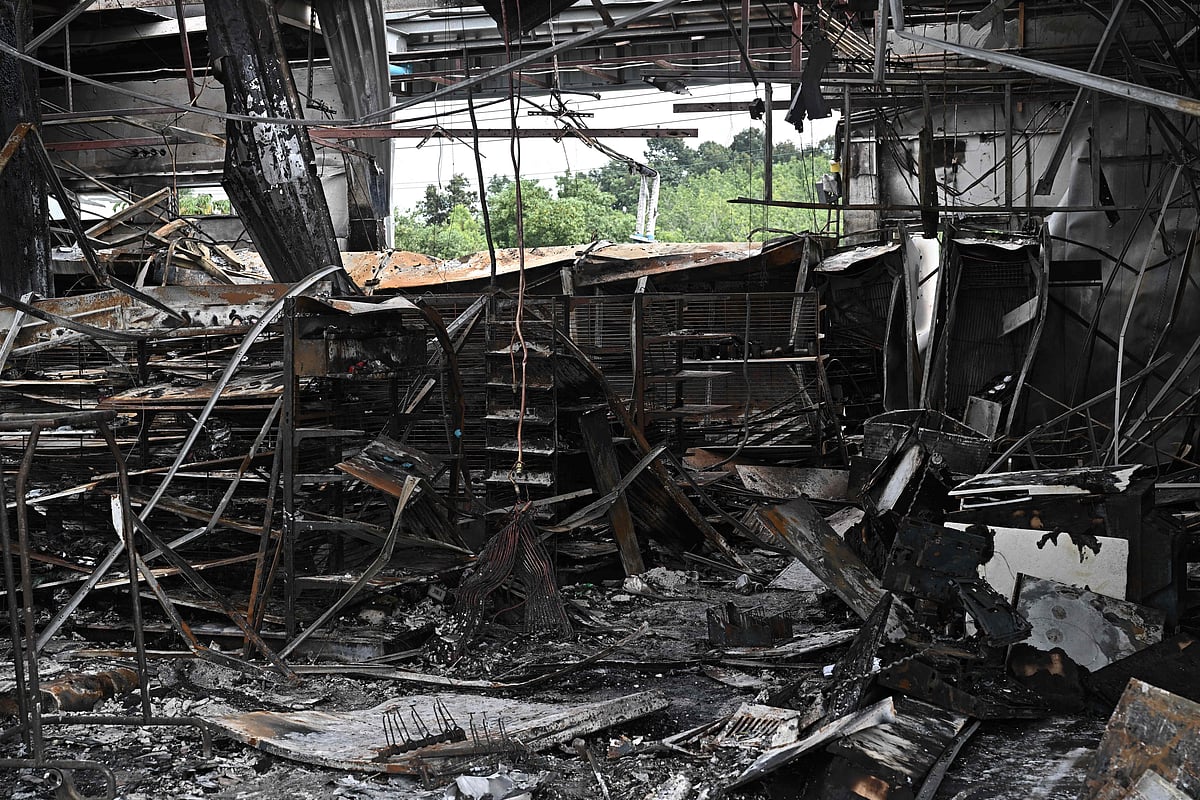 Damage from a fire caused by Cambodian artillery at a 7-11 convenience store is seen at a PTT gas station in the Thai border province of Sisaket province on 25 July, 2025