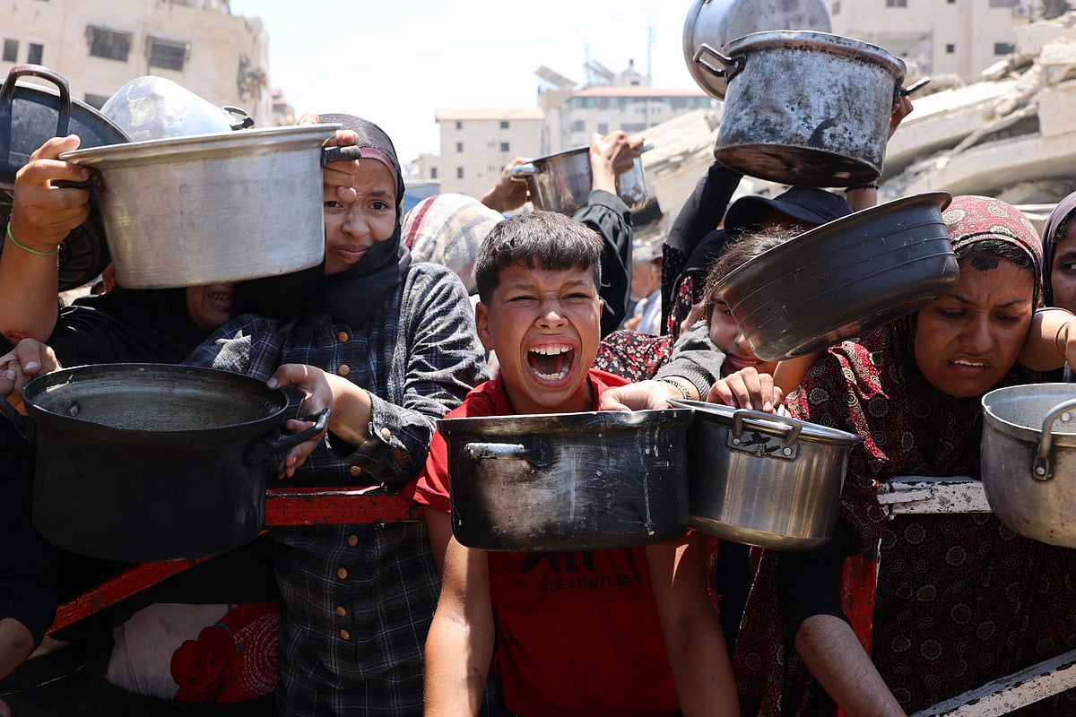 Palestinians crowd at a lentil soup distribution point in Gaza City in the northern Gaza Strip on 27 July, 2025.