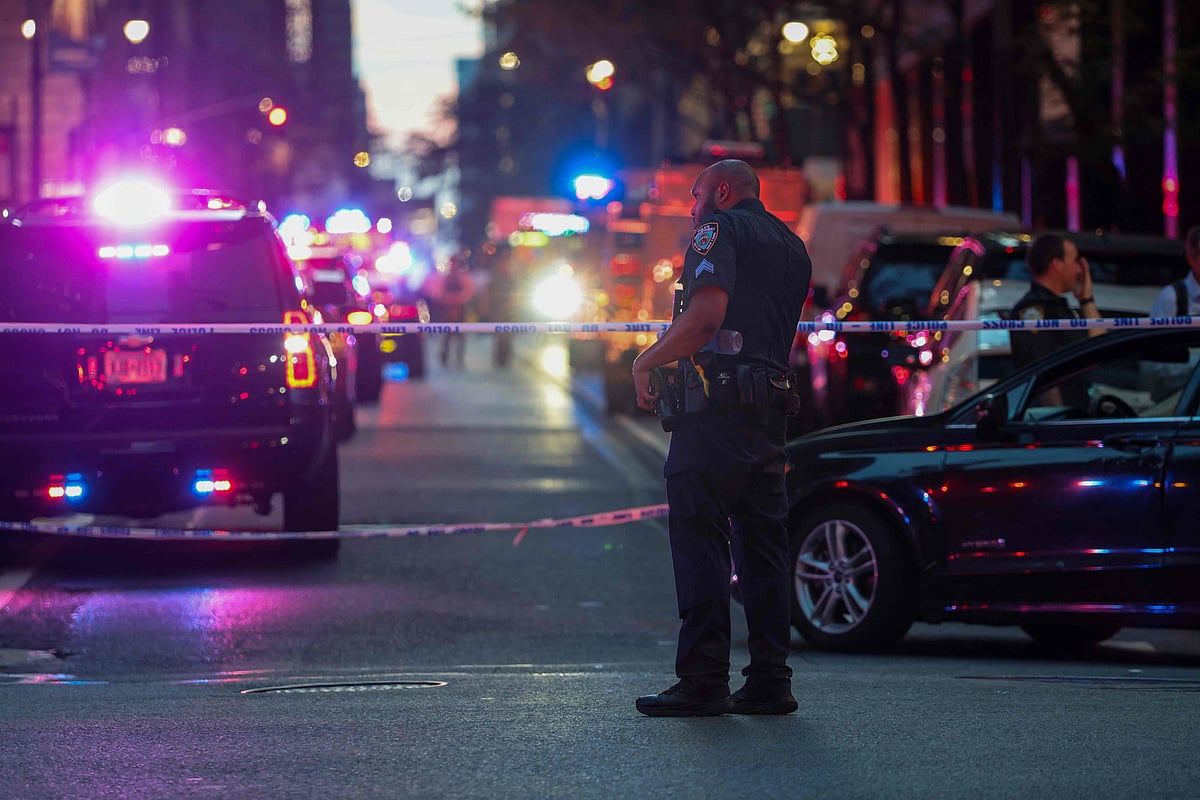 Police and others gather at a crime scene in midtown Manhattan after two people, including a police officer, were shot inside of an office building on 28 July 2025 in New York City