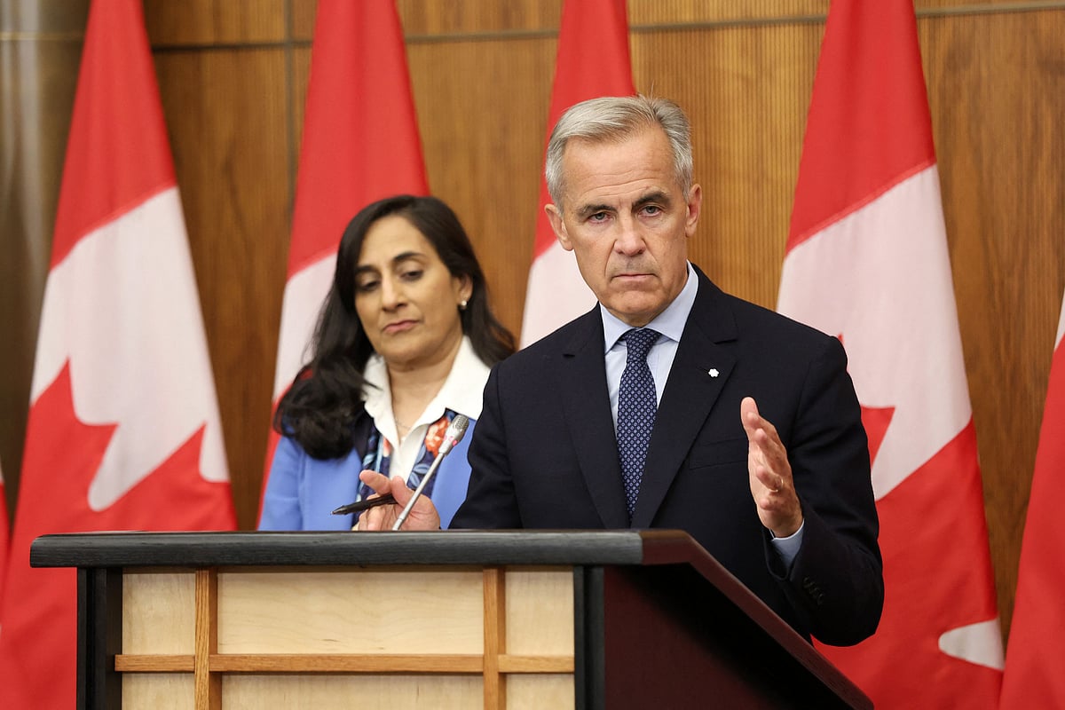 Canadian Prime Minister Mark Carney (R), flanked by Canadian Foreign Affairs Minister Anita Anand, speaks during a press conference after a Cabinet meeting to discuss both trade negotiations with the US and the situation in the Middle East, at the National Press Theatre in Ottawa, Ontario, Canada on 30 July 2025