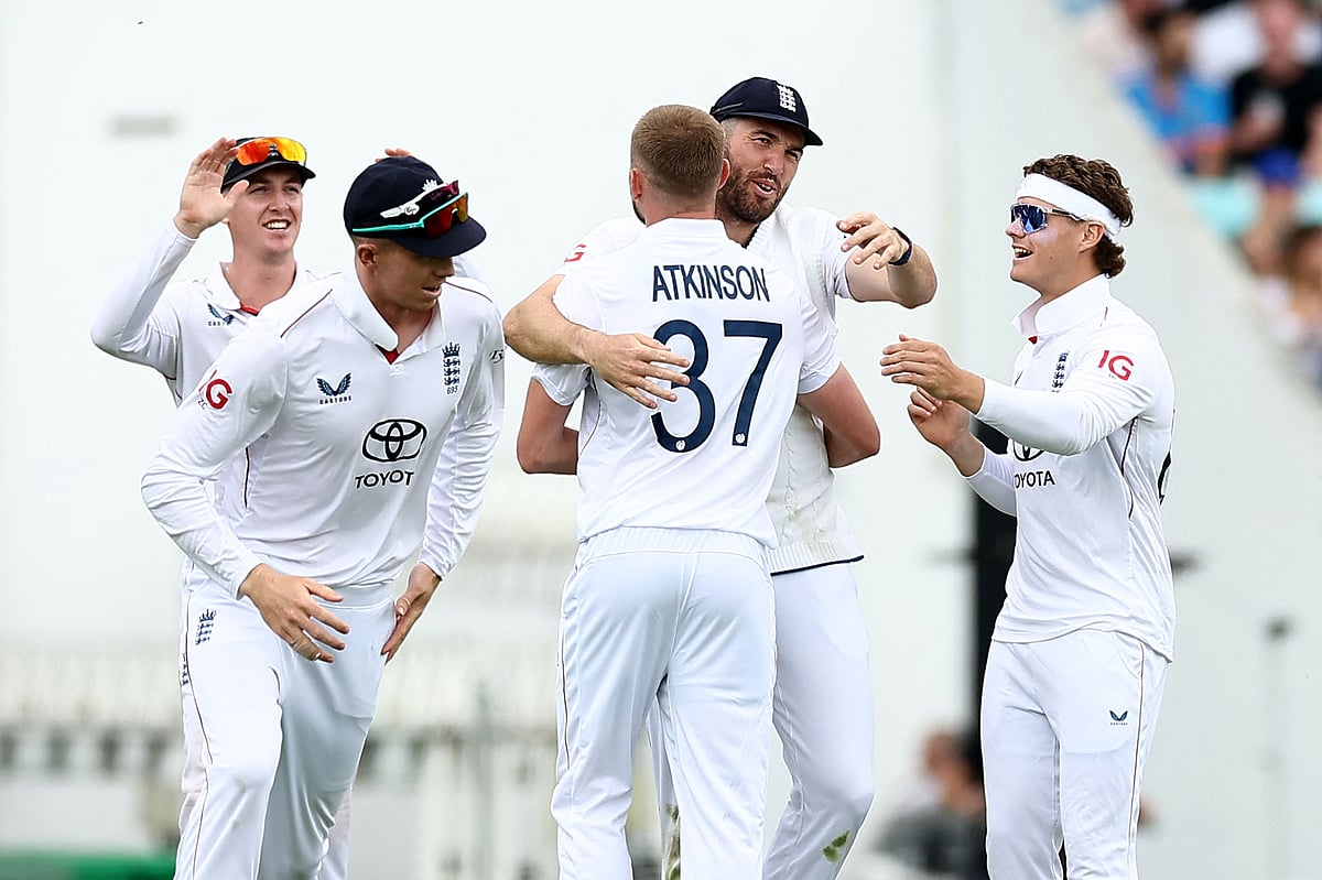 England’s Gus Atkinson is mobbed by teammates after taking the wicket of India’s Mohammed Siraj on day two of the fifth Test cricket match between England and India at The Oval in London on 1 August 2025