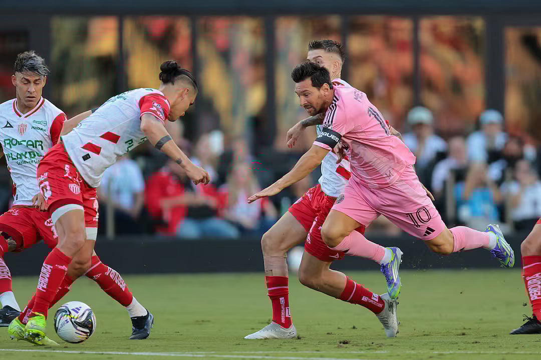 2 August, 2025; Fort Lauderdale, FL, USA; Inter Miami CF forward Lionel Messi (10) goes down after dribbling the ball against Necaxa defender Alexis Pena (4) and Necaxa midfielder Raul Sanchez (11) during the first half of a Leagues Cup group stage match at Chase Stadium.
