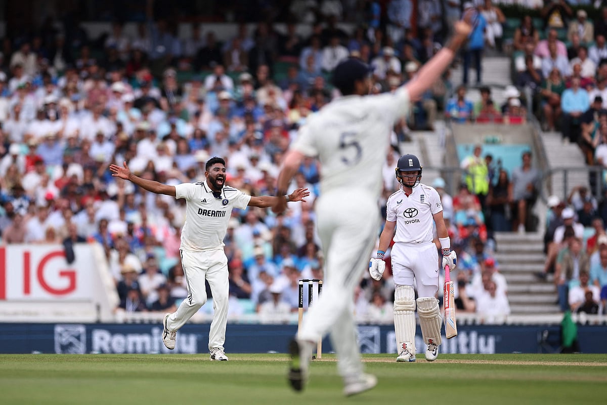 India's Mohammed Siraj (L) celebrates taking the wicket of England's Ollie Pope on day four of the fifth Test cricket match between England and India at The Oval in London on August 3, 2025