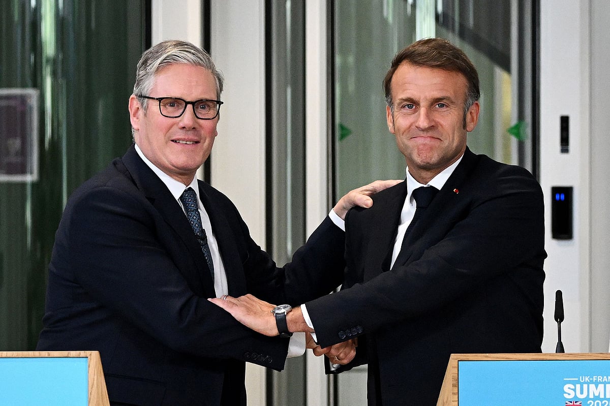 Britain's Prime Minister Keir Starmer (L) and France's President Emmanuel Macron (R) embrace during a joint press conference following a meeting of the Coalition of the Willing at a military base at Northwood Headquarters in north-west London, on 10July  2025.