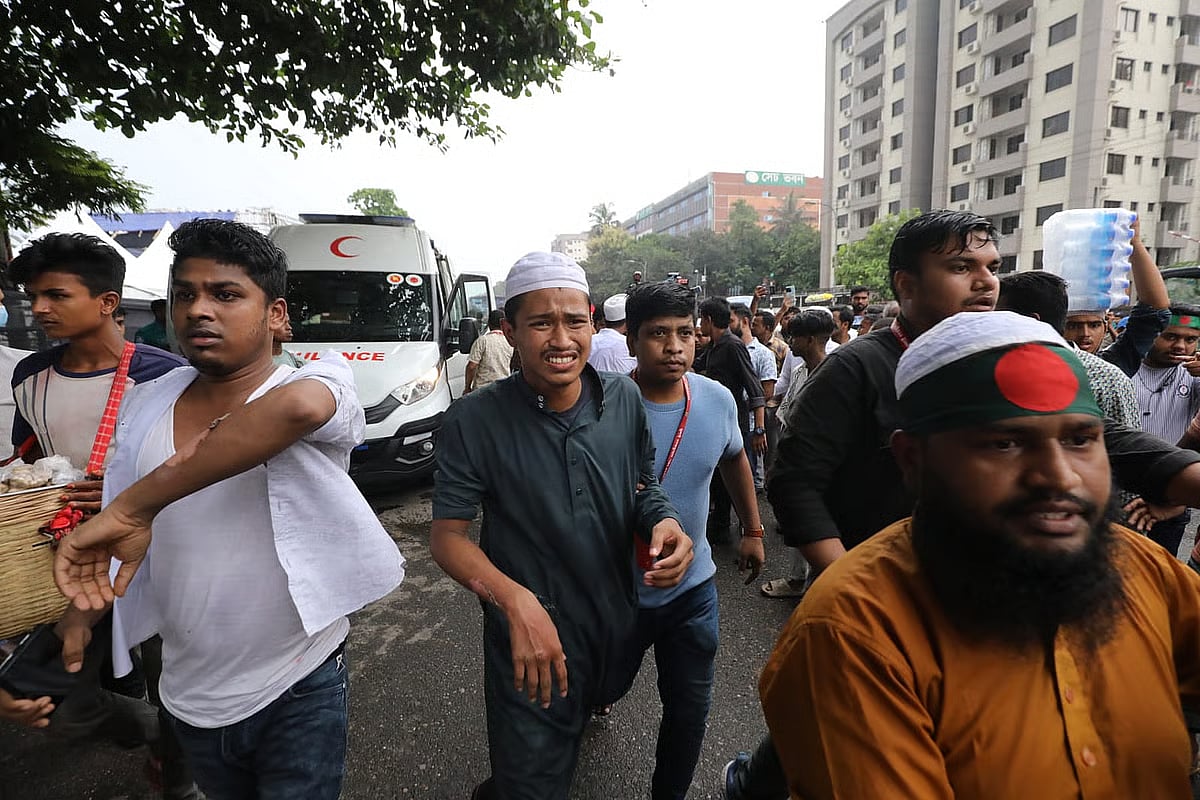 Photos shows an injured person being taken to an ambulance after the gas balloon explosion at the '36 July Celebration' venue on Manik Mia Avenue in Dhaka on 5 August 2025.