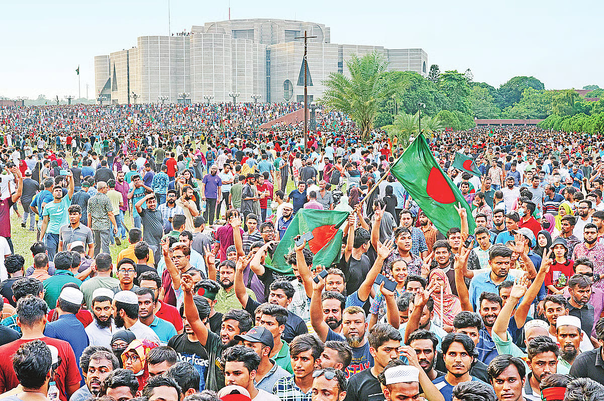 People celebrate the fall and fleeing of former Prime Minister Sheikh Hasina on the parliament premises on 5 August 2024