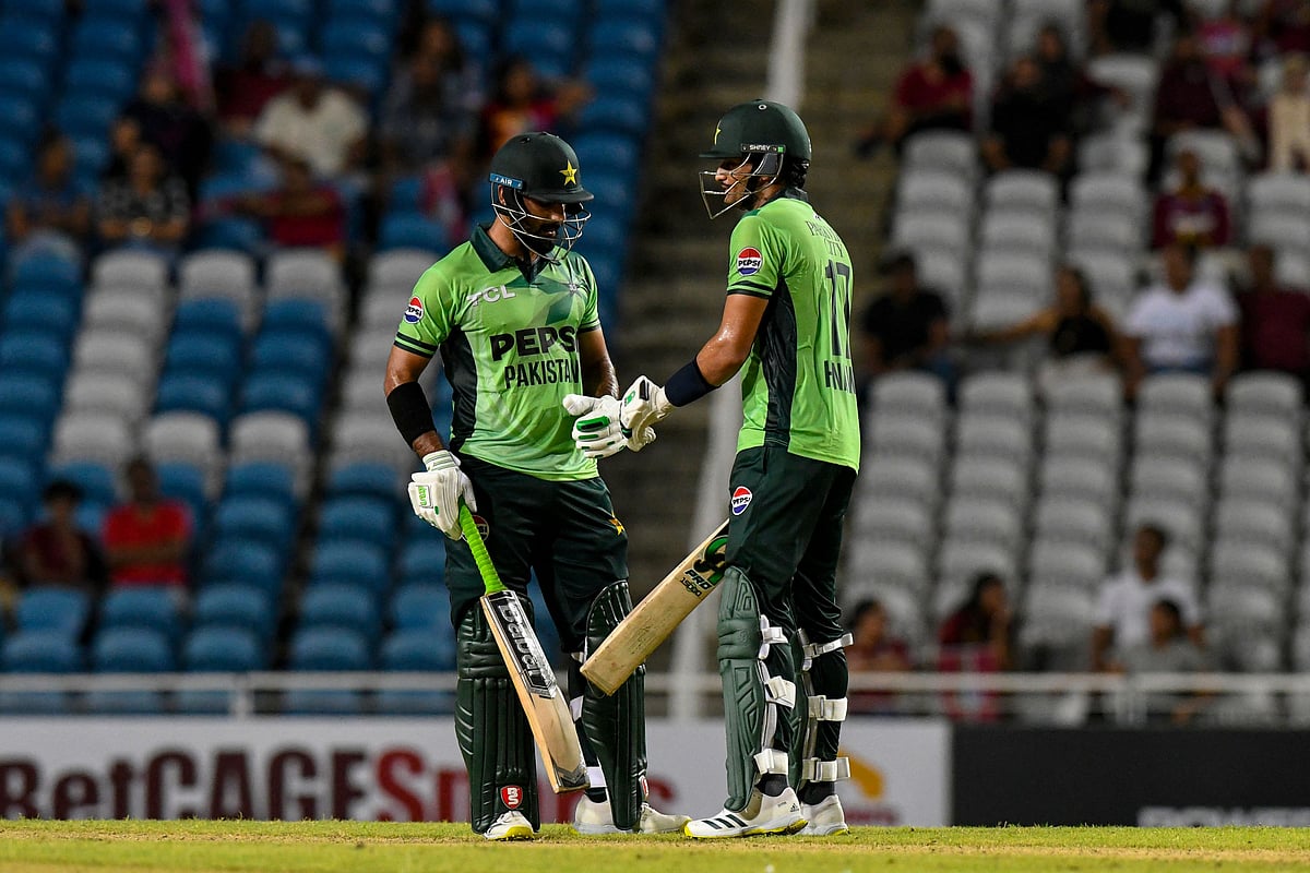 Hussain Talat (L) and Hasan Nawaz (R) of Pakistan celebrate a 100-run partnership during the first One Day International (ODI) cricket match between West Indies and Pakistan at Brian Lara Cricket Academy in Tarouba, San Fernando, Trinidad and Tobago, on 8 August 2025.