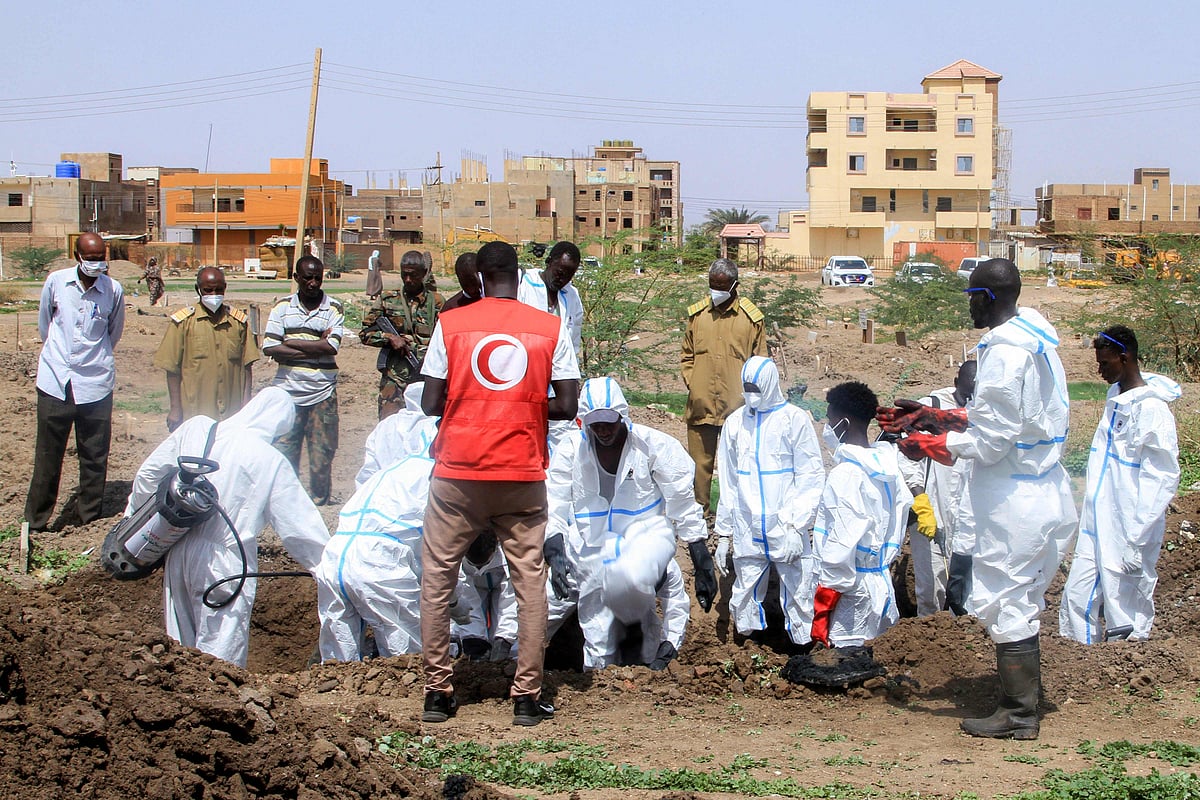 Members of the Sudanese Red Crescent and forensic experts exhume the remains of people from makeshift graves for reburial in the local cemetery in Khartoum's southern suburb of al-Azhari on 2 August, 2025 after the dead were buried in a rush when the area was under control of the Rapid Support Forces (RSF) paramilitaries.