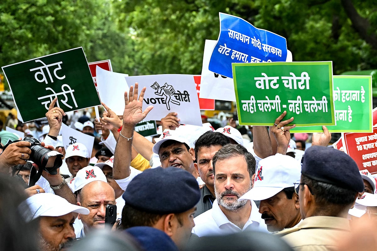 Indian National Congress (INC) party leader Rahul Gandhi (C) takes part in a protest led by India's opposition parties in New Delhi on 11 August 2025, to condemn alleged electoral malpractices and the Special Intensive Revision (SIR) of electoral rolls ahead of state elections in India’s Bihar state. The Election Commission of India (ECI) announced the revision of the voter rolls in June, asking voters to prove their citizenship, which requires documents few possess in a registration revamp set to be applied nationwide, triggering disenfranchisement fears.
