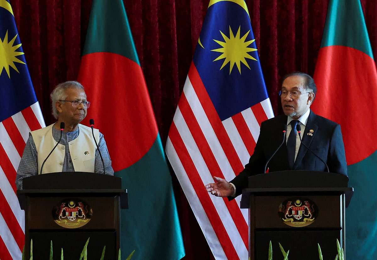 Malaysian Prime Minister Anwar Ibrahim speaks as Chief Adviser of Bangladesh Interim Government Muhammad Yunus looks on during a press conference at Putrajaya, Malaysia, 12 August 2025.