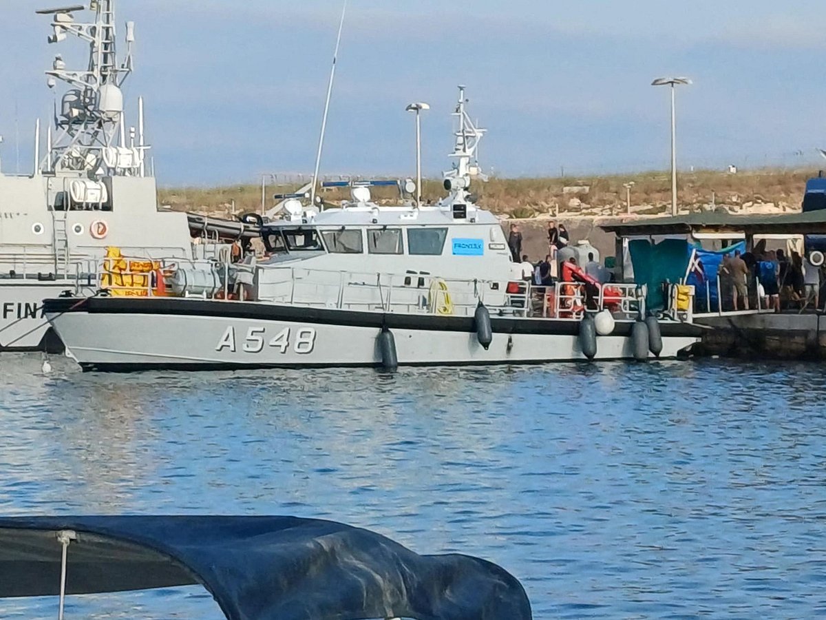 Migrants disembark from the boat that rescued them after their ship sank off the coast of Italy's Lampedusa island in the harbour of Italian island of Lampedusa on 14 August 2025.