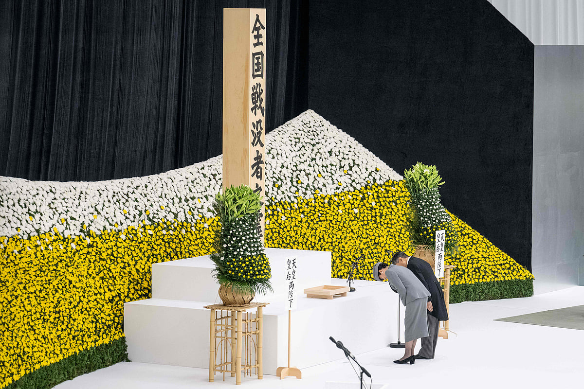 Japan's Emperor Naruhito (L) and Empress Masako bow as they arrive at a memorial service marking the 80th anniversary of Japan's surrender in World War II at the Nippon Budokan hall in Tokyo on 15 August 2025.