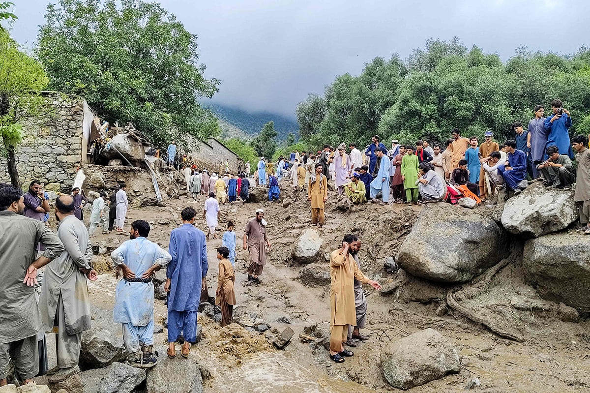 People gathered at the site of a flashflood in Salarzai Tehsil of Pakistan's Bajaur district on 15 August 2025.