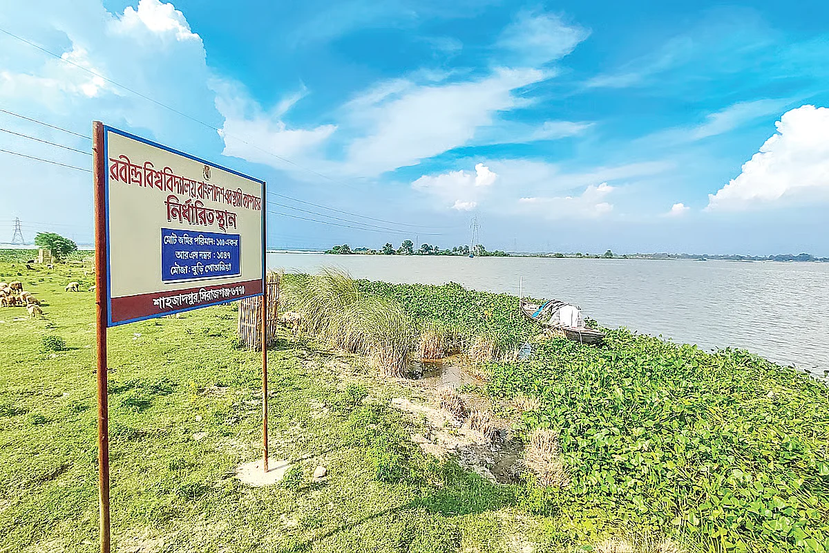 A signboard marks permanent campus of Rabindra University on Chalan Beel in Pabna