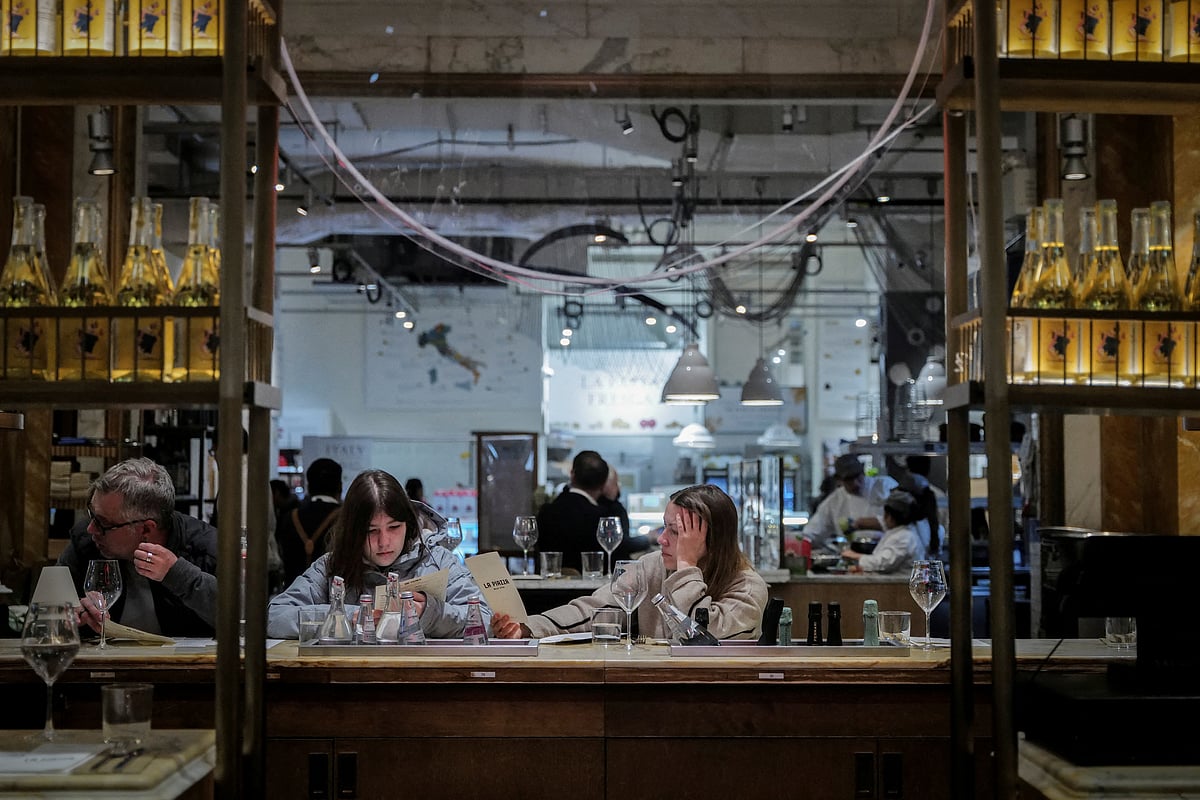 People look at the menu, at a bar in New York City, US, 9 April 2025.