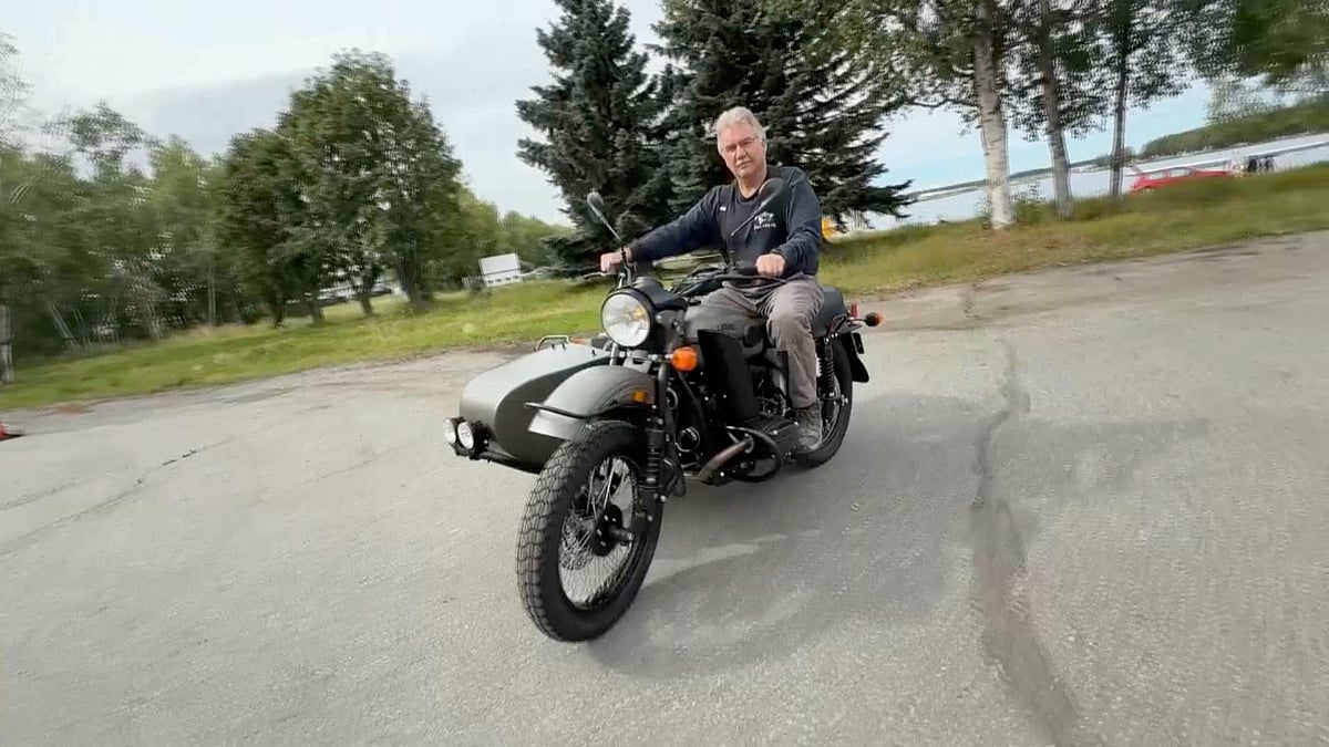 Alaska resident Mark Warren rides his new Ural motorcycle, a gift from Russian President Vladimir Putin, handed over by a Russian Embassy official, in Anchorage, Alaska, U.S., in this still image from video released on 18 August 2025.