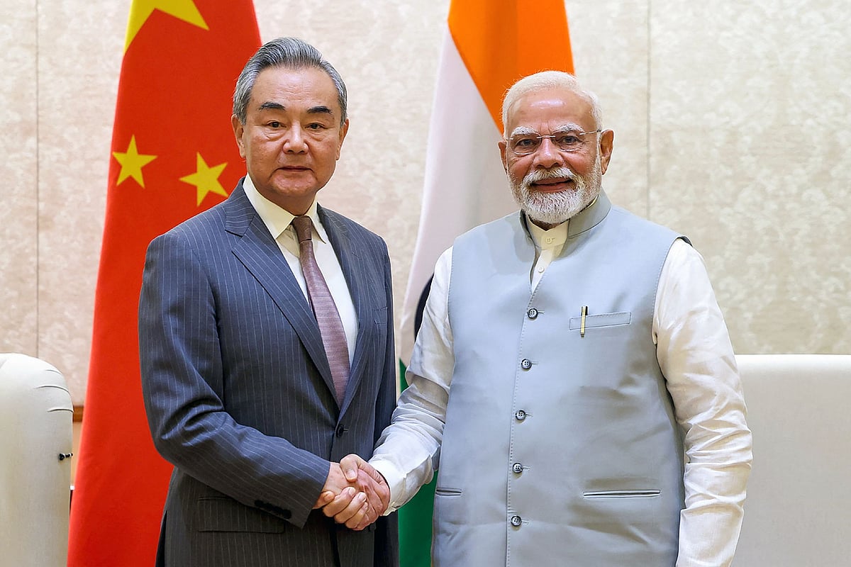 This handout photograph taken on 19 August 2025 and released by the Indian Press Information Bureau (PIB) shows India’s Prime Minister Narendra Modi shaking hands with Beijing’s Foreign Minister Wang Yi during a bilateral meeting in New Delhi on 19 August 2025