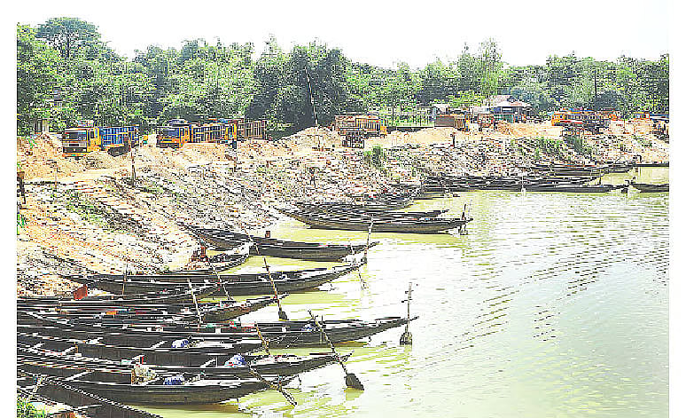 Sand extraction is going on from areas beyond leased out of Borogang River. This sand has been kept at Ferryghat area and is being transported by trucks. The photo was taken on 18 August 2025