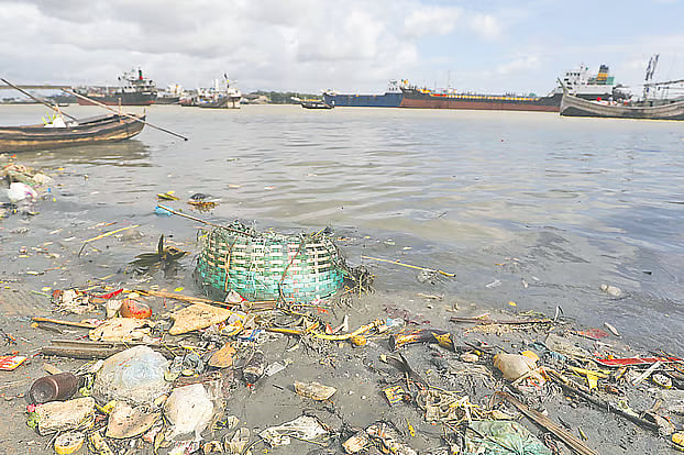 Plastic bottles, polythene bags, torn fishing nets, and plastic baskets floating in the Karnaphuli River. The photo was taken Tuesday afternoon at New Fishery Ghat in Chattogram city.