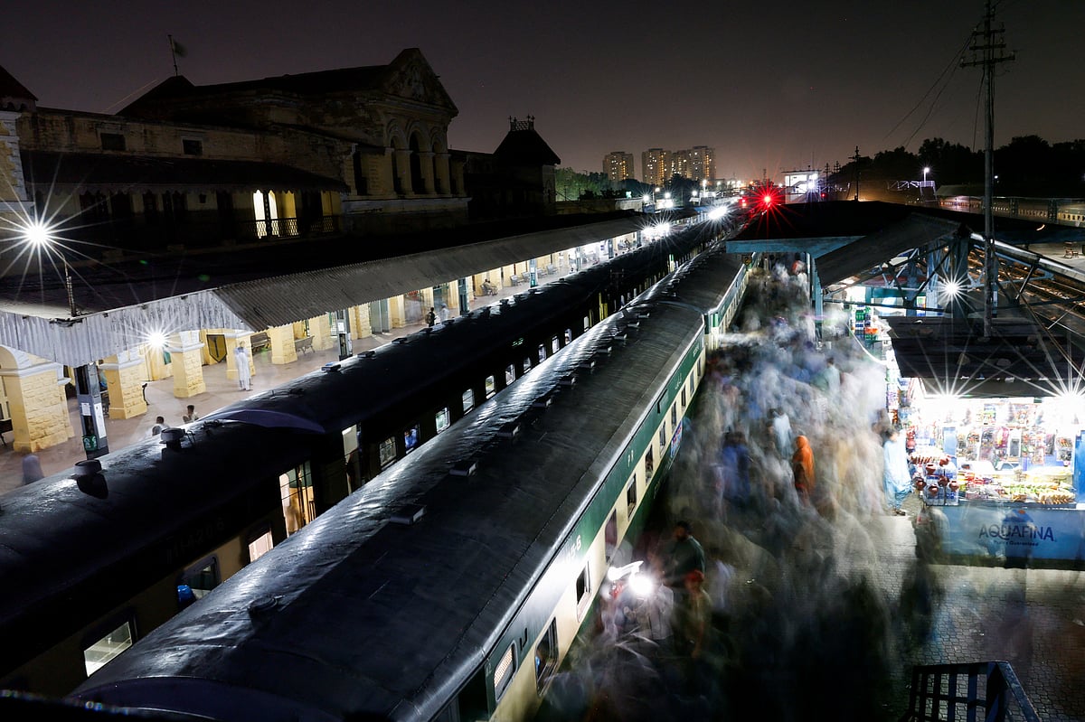 Passengers get on board a train at the Cantonment railway station in Karachi, Pakistan, 8 April 2024.