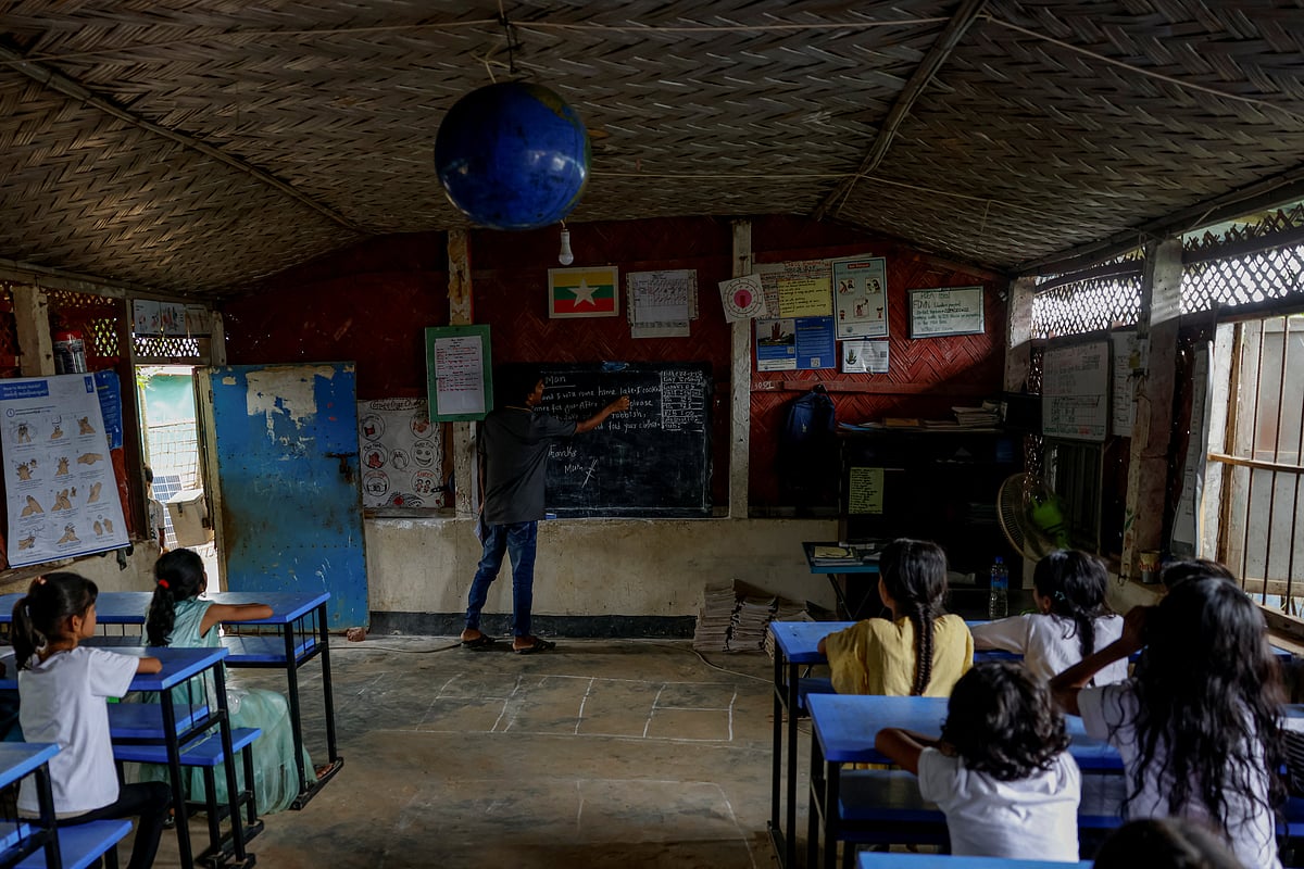 Mohammed Jaber teaches English to students at a WFP Food Assistance and Learning Center, inside the refugee camp, in Cox's Bazar, Bangladesh, 17 August 2025.