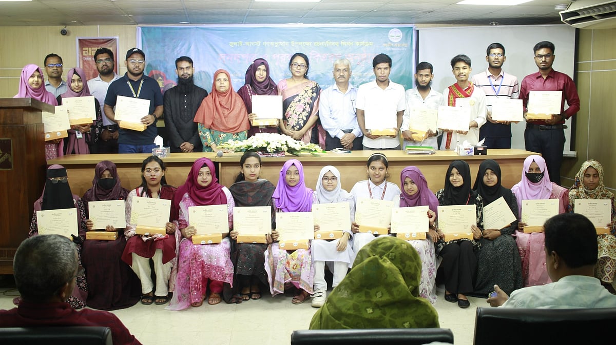 Guests, award-winners and organiser pose for a group photo at an event organised by the National Book Centre at its auditorium in Dhaka on Thursday