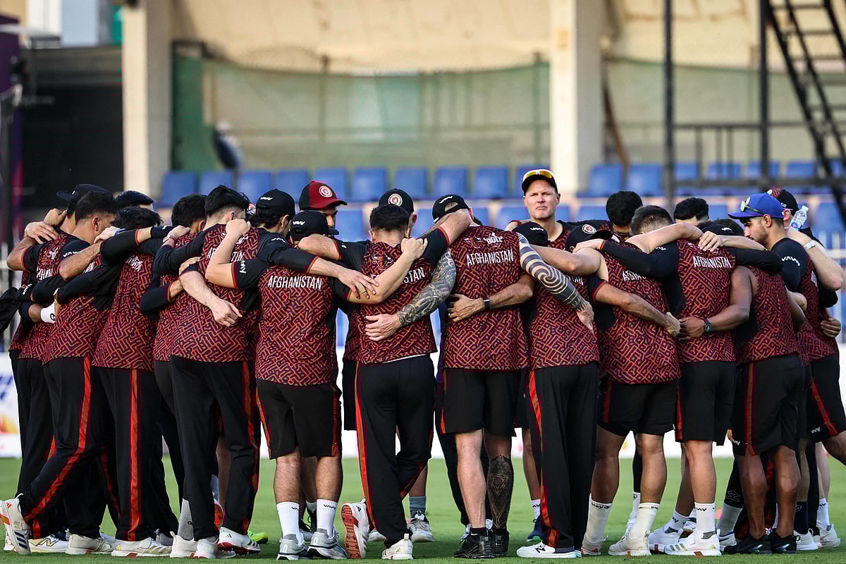 Afghanistan's players gather for a huddle before their UAE Tri-Series match against Pakistan in Sharjah on 29 August 2025.