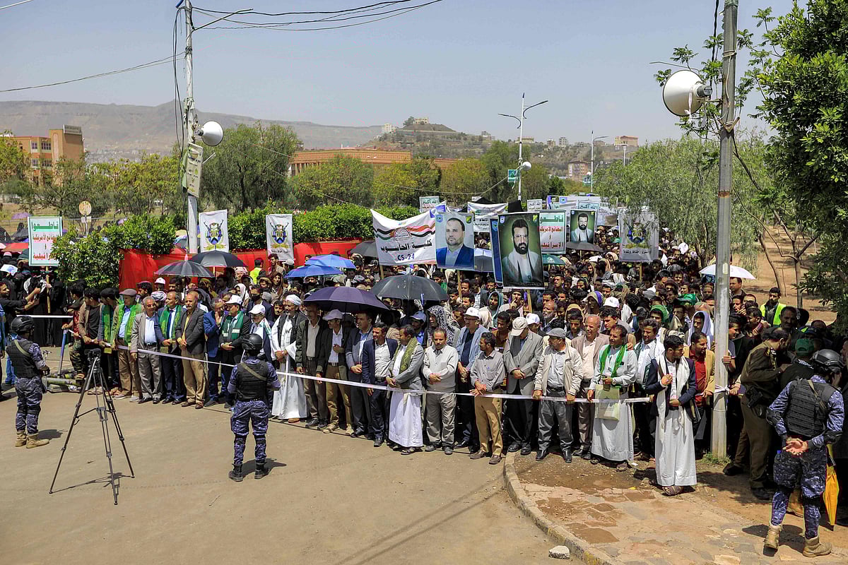 Members of security forces loyal to Yemen's Huthis stand guard as protesters gather during an anti-Israel, anti-US, and pro-Palestinian rally organised by the staff and students of Sanaa University in Yemen's Huthi-controlled capital Sanaa on August 27, 2025.